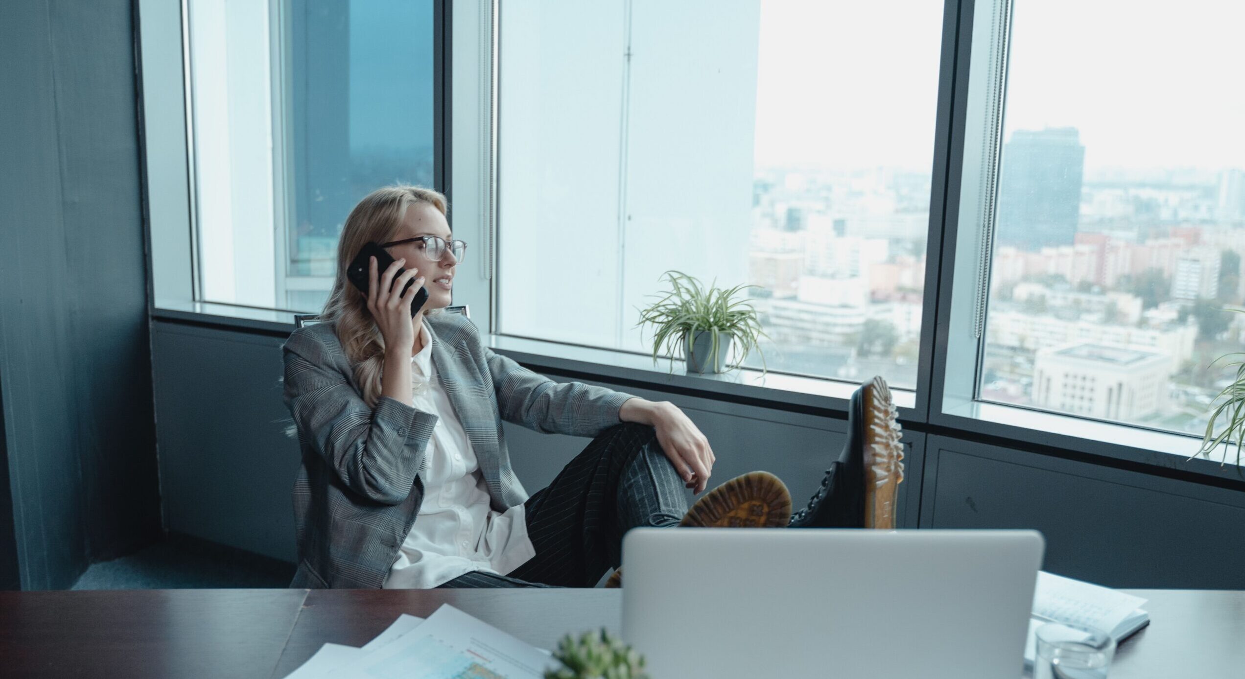 Female founder in executive office taking a strategic phone call, representing focused leadership after building effective delegation structures